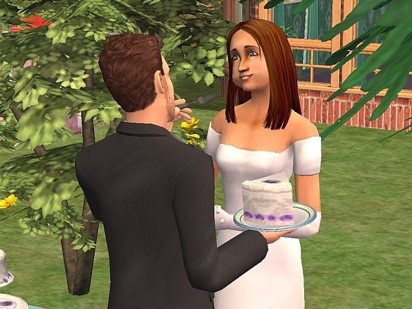 Taryn feeds Hugh some cake